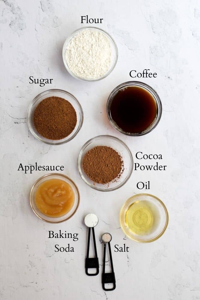 ingredients for eggless chocolate cupcakes labeled with black text on a white backdrop.