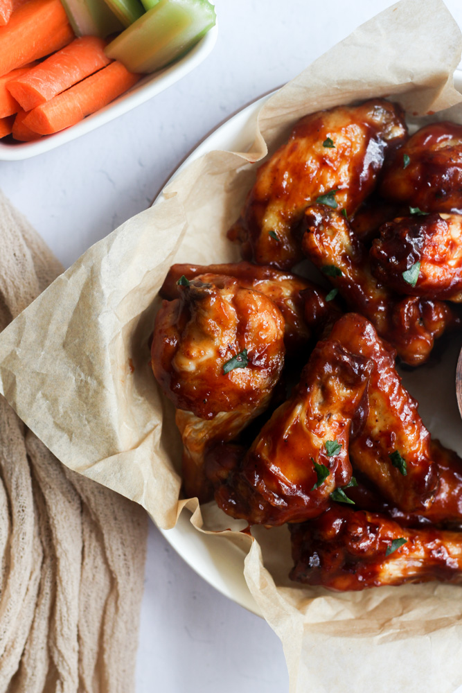 healthy BBQ wings on brown parchment paper.