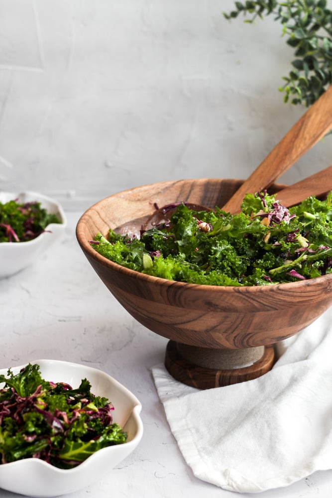 healthy kale crunch salad copycat recipe in a wood bowl served in 2 small white bowls.