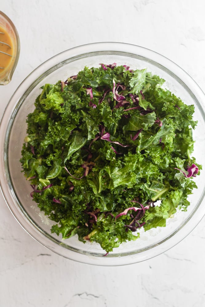 kale and red cabbage in a clear bowl.