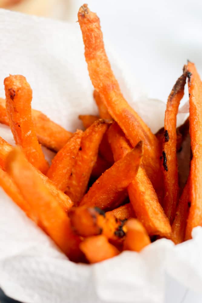 crispy frozen sweet potato fries on a white napkin.