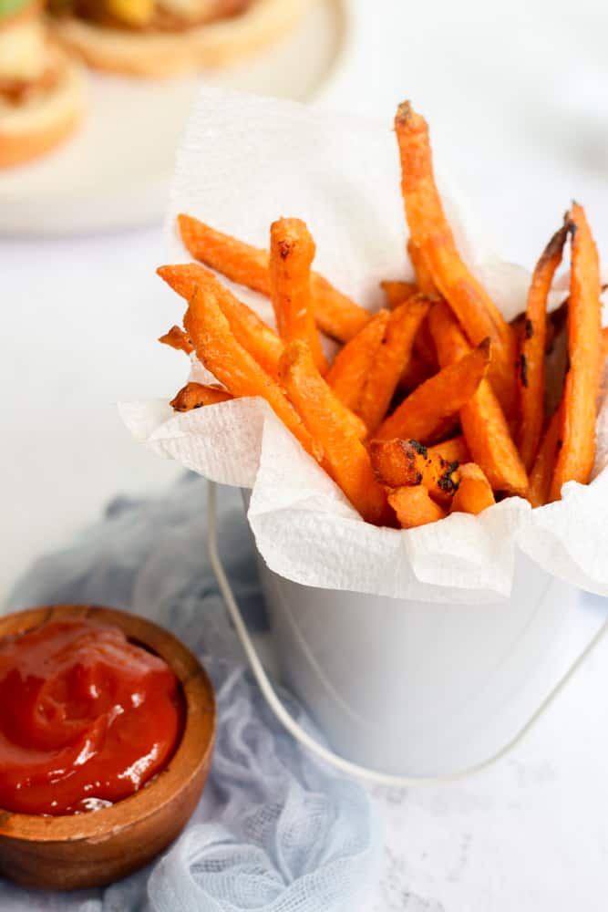 air fryer sweet potato fries in a bucket to pair with meatballs.