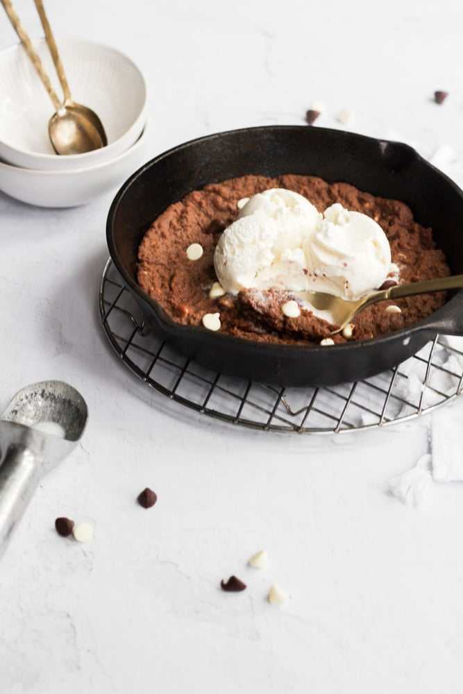 triple chocolate skillet cookie topped with vanilla ice cream.