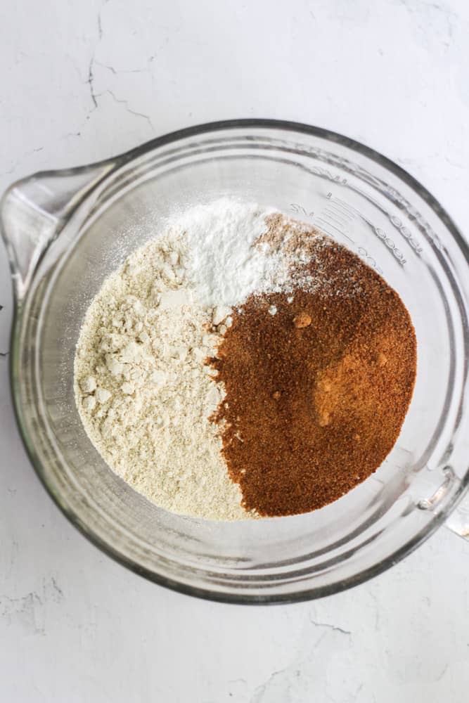 gluten free dry ingredients for a cake in a clear bowl.
