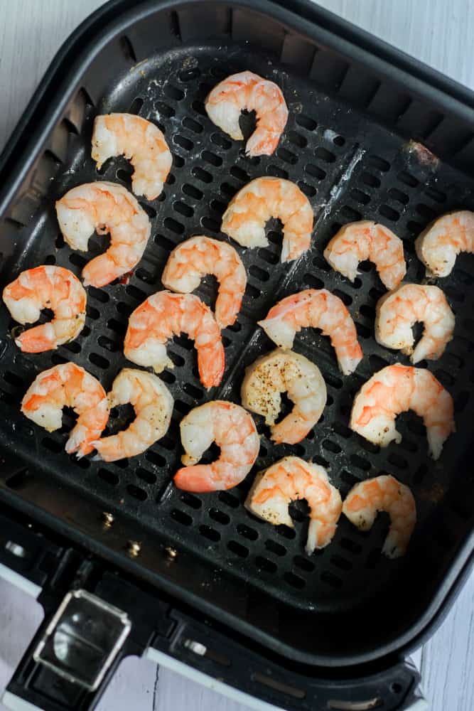 shrimp cooked in air fryer basket.