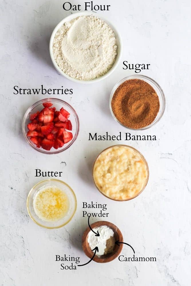 ingredients for a healthy strawberry banana cake labeled with black text on a white backdrop.