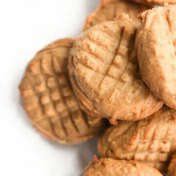 2 ingredient peanut butter cookies piled on top of one another.