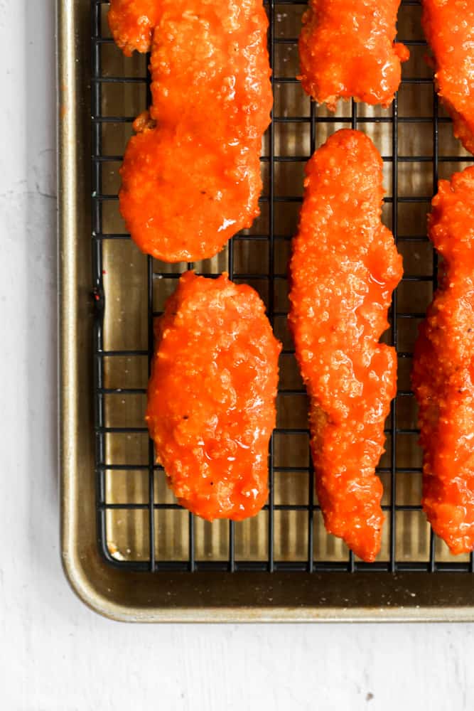 healthy buffalo chicken on a wire rack.