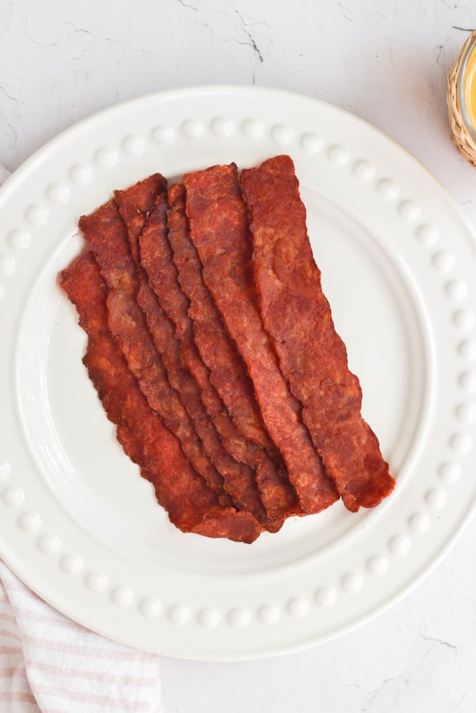 strips of bacon on white plate.