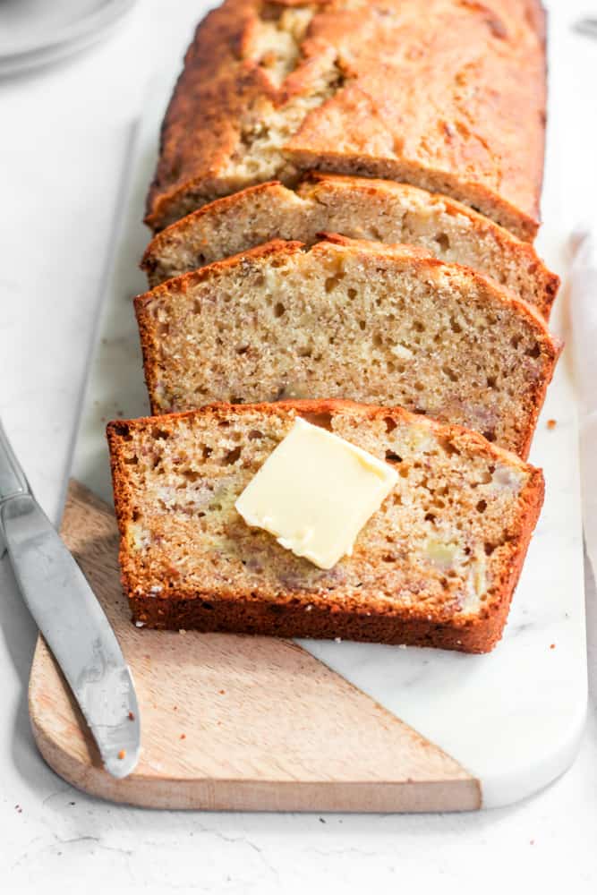 slices of easy banana bread with a pat of butter.