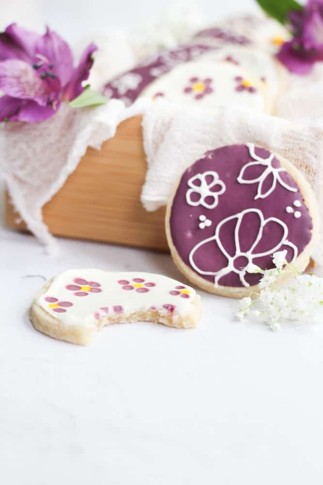 decorated sugar cookies with a bite taken out of it.