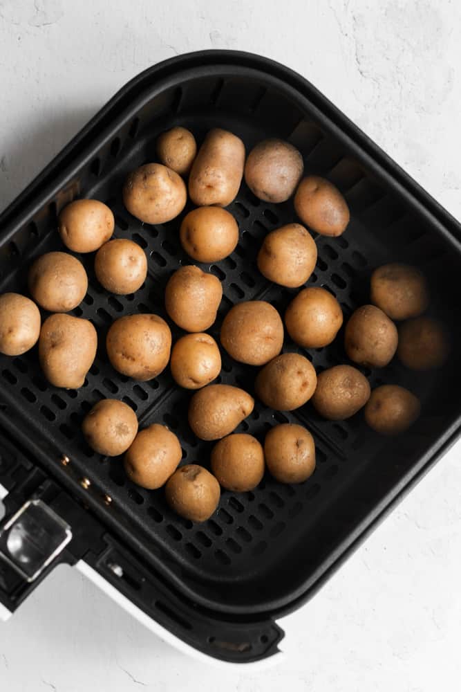 baby potatoes in air fryer basket.