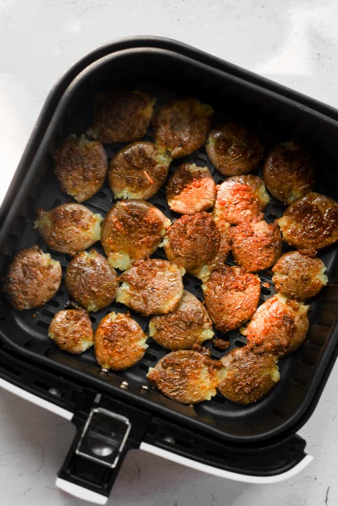 smashed potatoes cooked in air fryer basket.