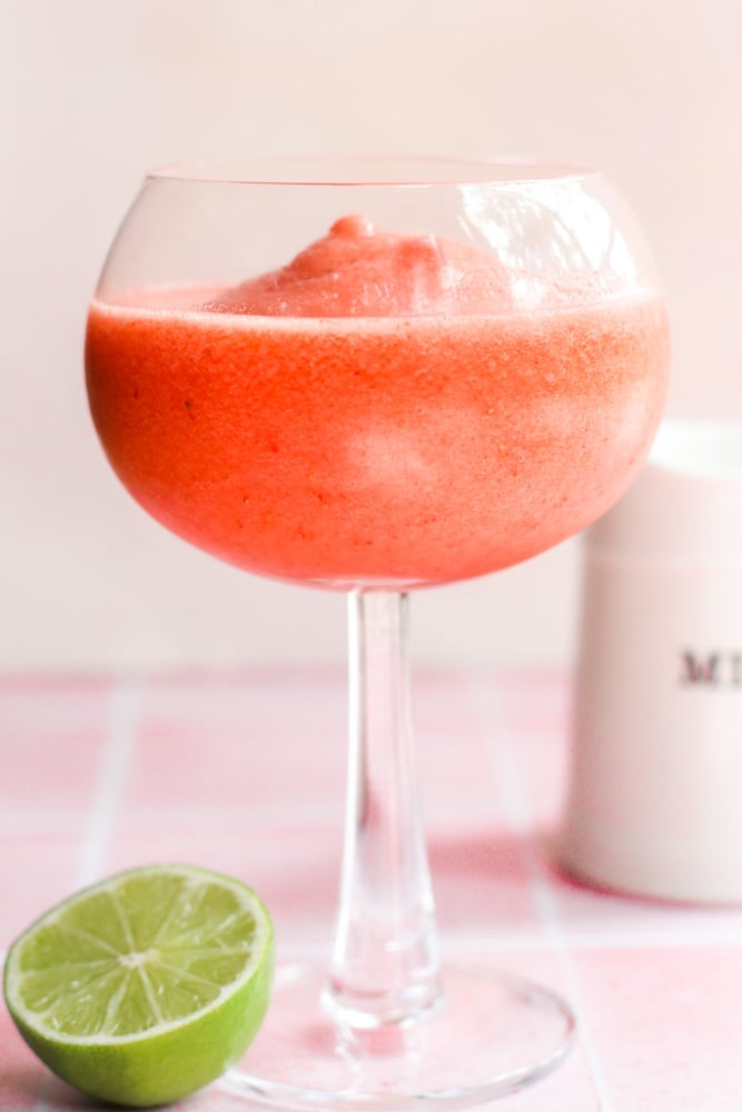 frozen strawberry daiquiri in a cocktail glass.