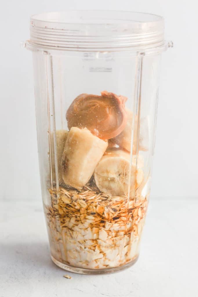 oats, banana, and peanut butter in blender cup.