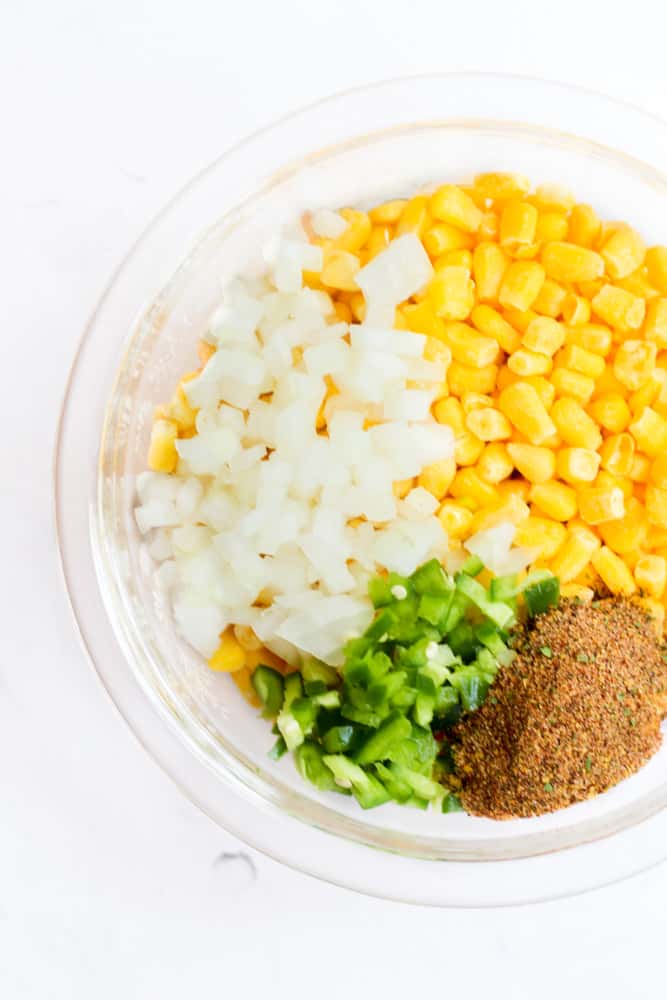 ingredients forroasted frozen corn in a glass bowl.