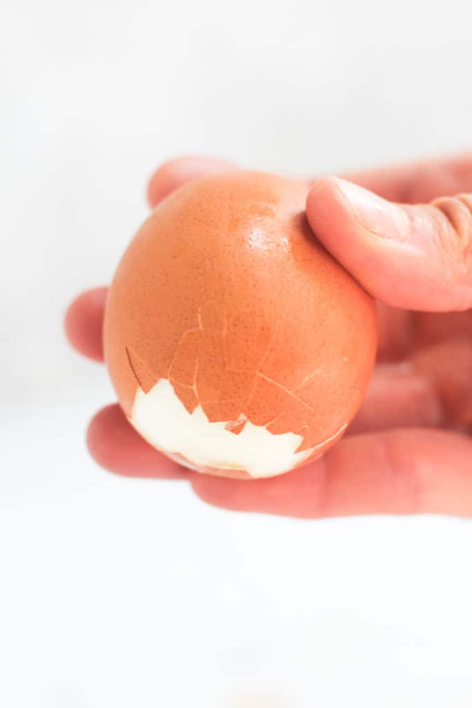 hand peeling an air fryer egg.