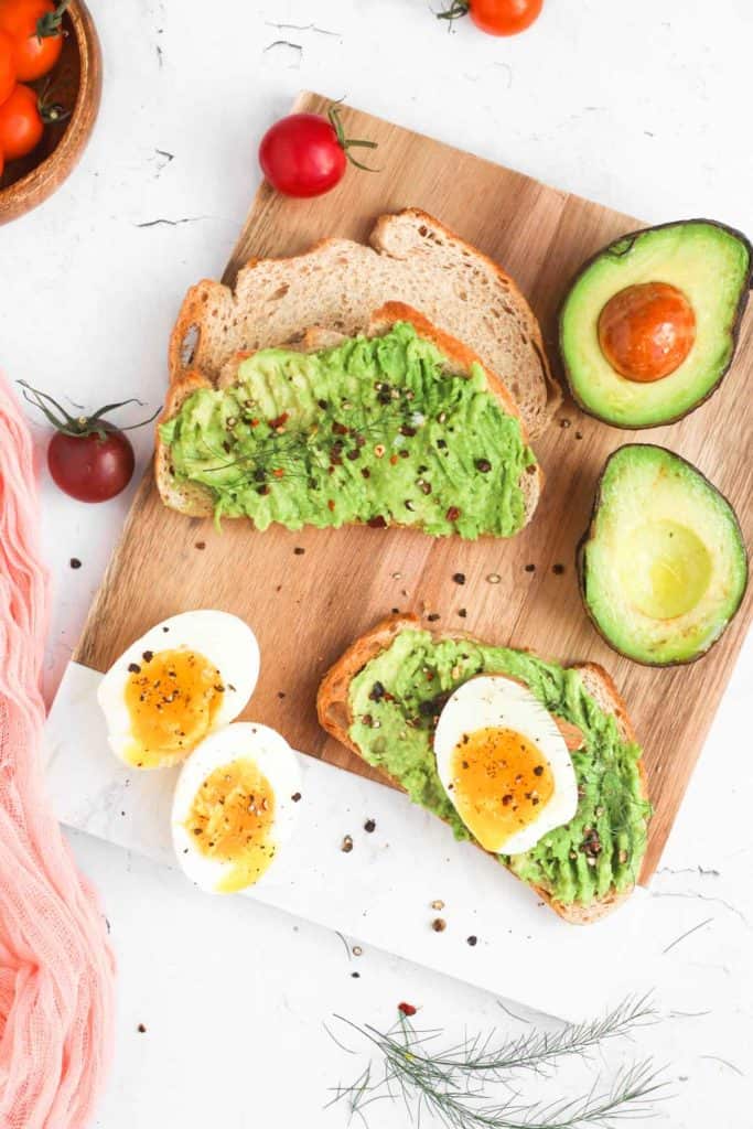 avocado toast board with air fryer soft boiled eggs.