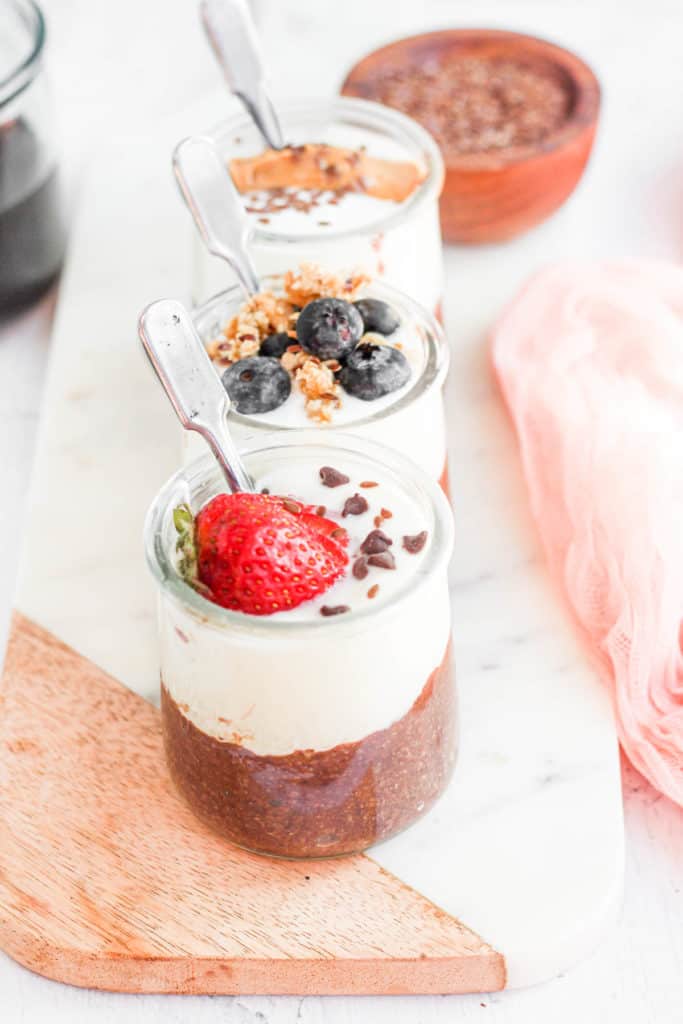 Flaxseed pudding in jars topped with fruit.