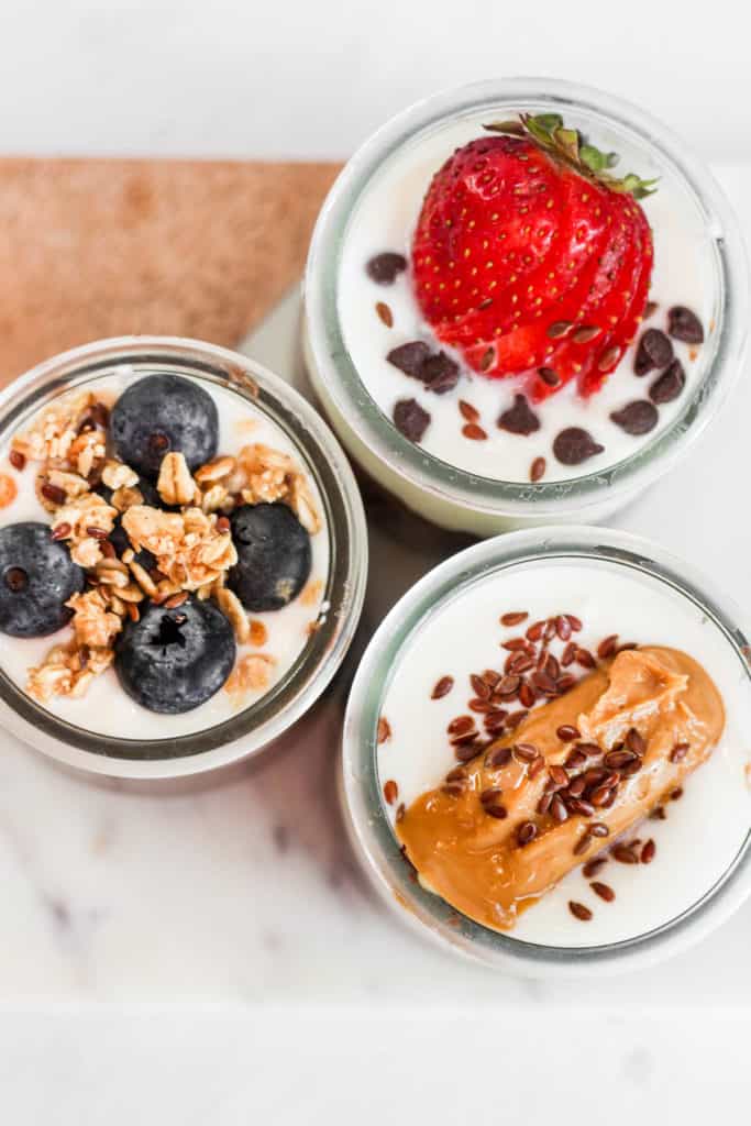 glass jars of flax pudding with toppings.