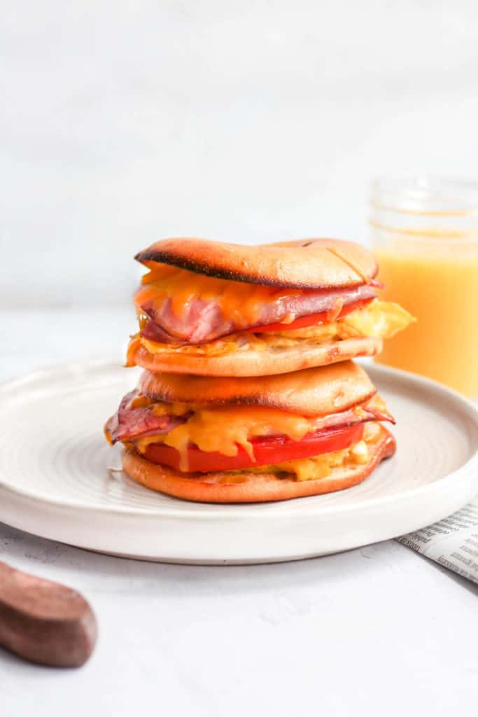 healthy breakfast sandwiches stacked on white plate.