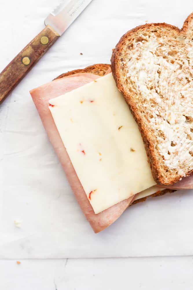 buttered bread with slice of cheese and ham.