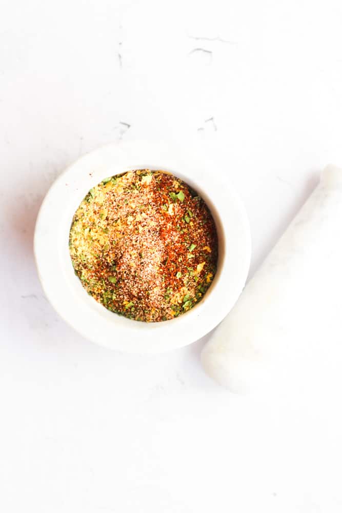 elote spice blend in a white mortar and pestle.