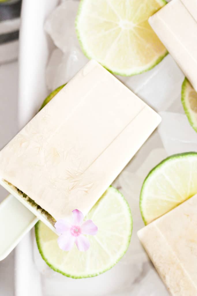 healthy frozen lime pops on ice with flowers.