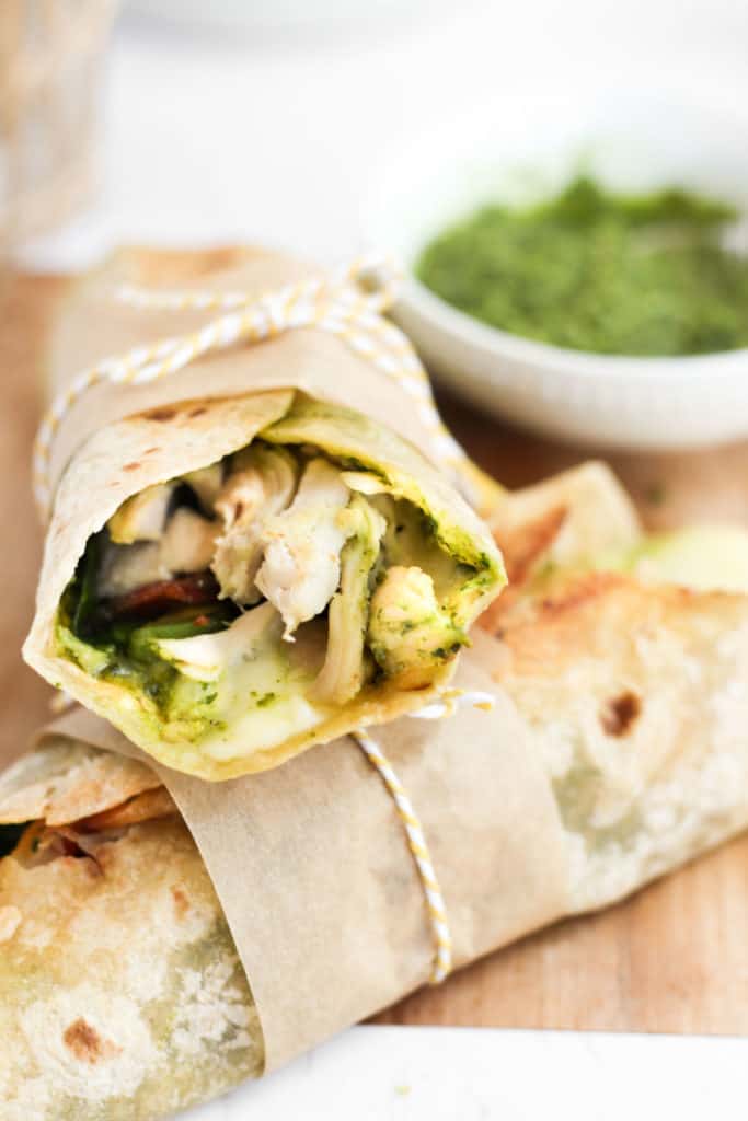 wrap with pesto and chicken stacked on top of each other.