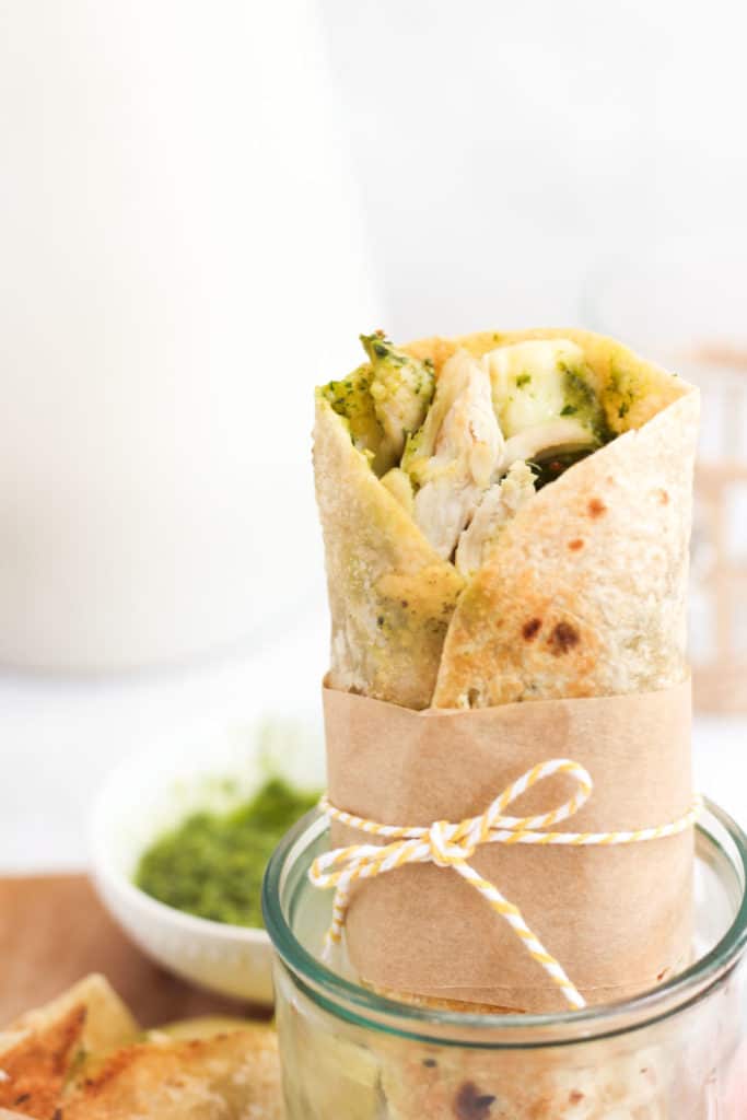 chicken wrap with pesto tied with yellow string.