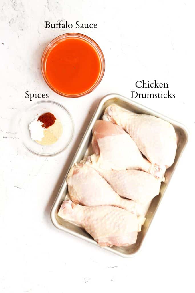 ingredients for air fryer buffalo chicken legs labeled with black text.