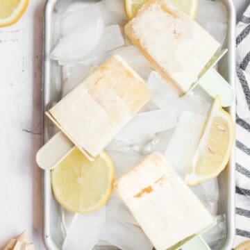 lemonade popsicles on a tray with ice cubes.