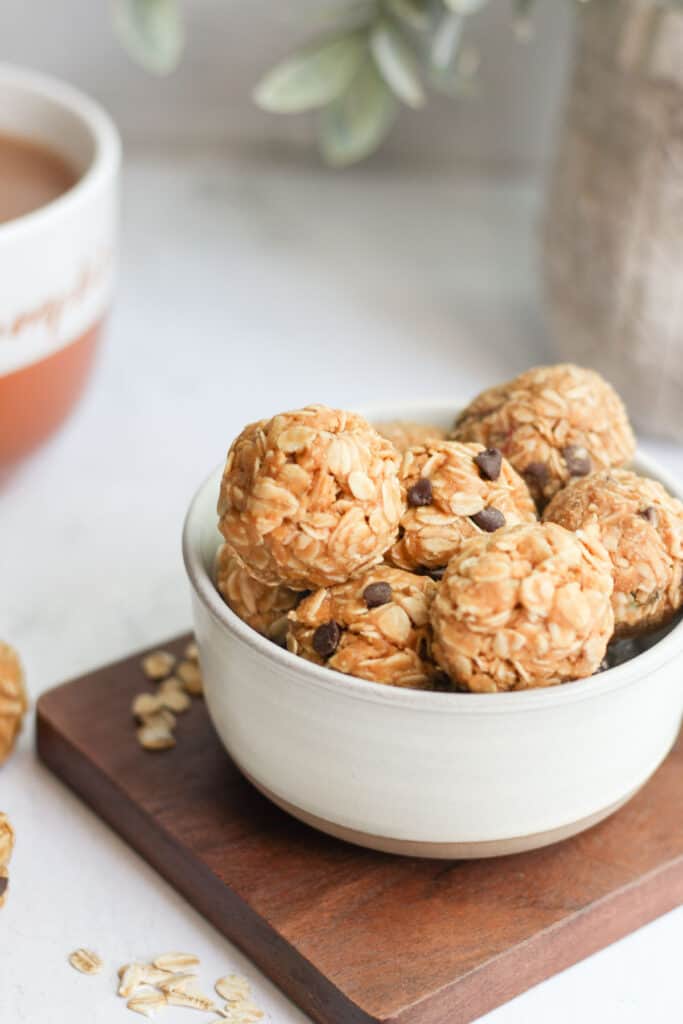 3 ingredient oat balls in white bowl with mini chocolate chips.