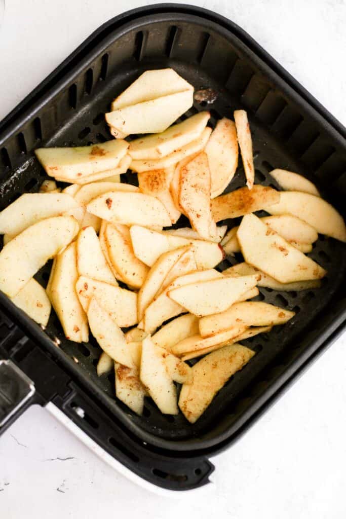 apple slices in air fryer basket.
