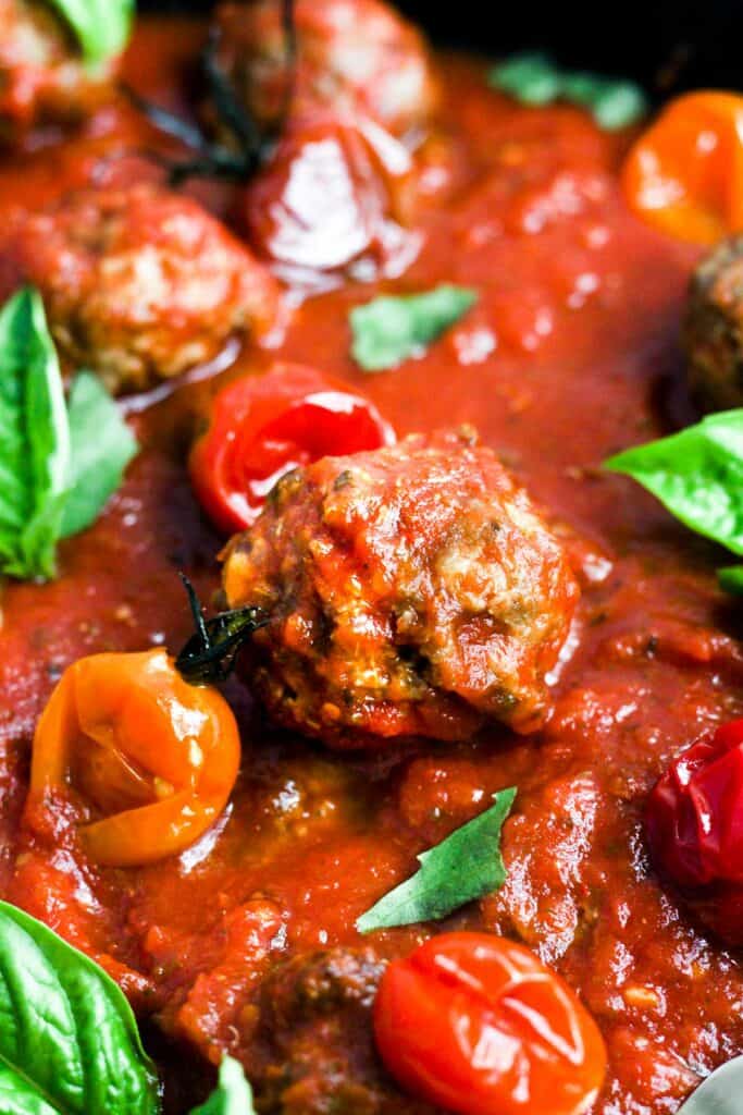 egg free meatballs in tomato sauce with basil.