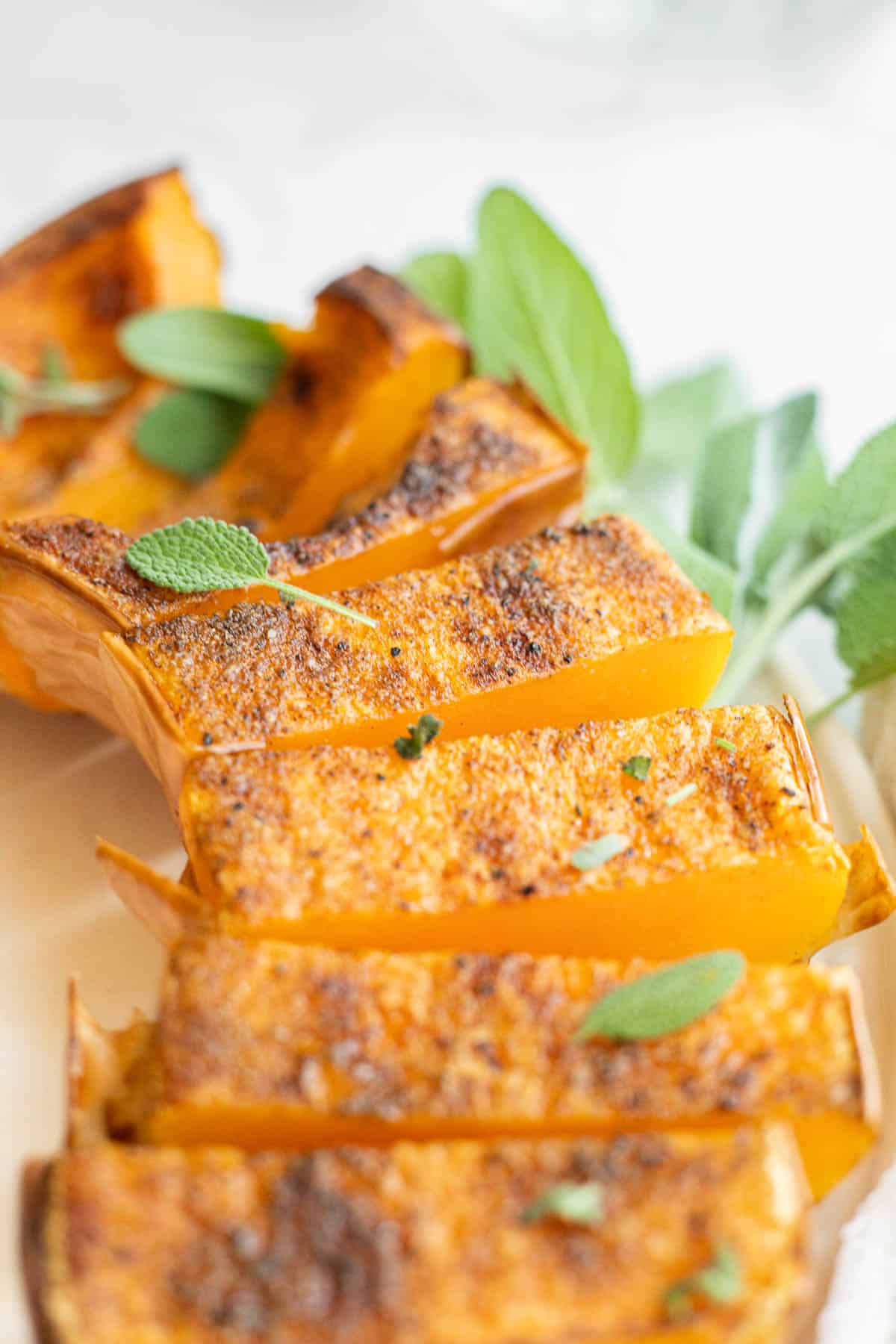 seasoned butternut squash topped with sage leaves.