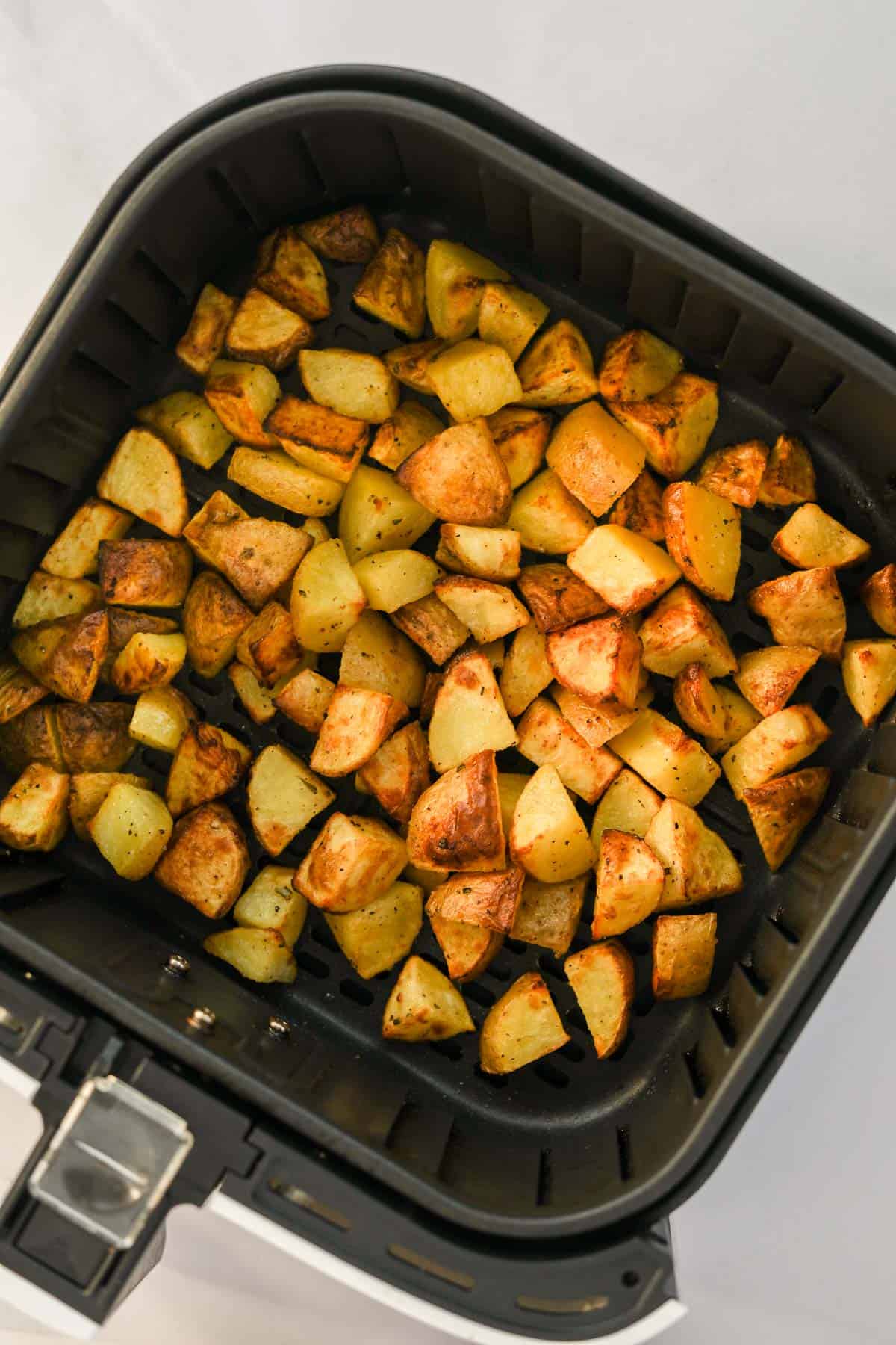 crispy roasted potatoes in air fryer basket.