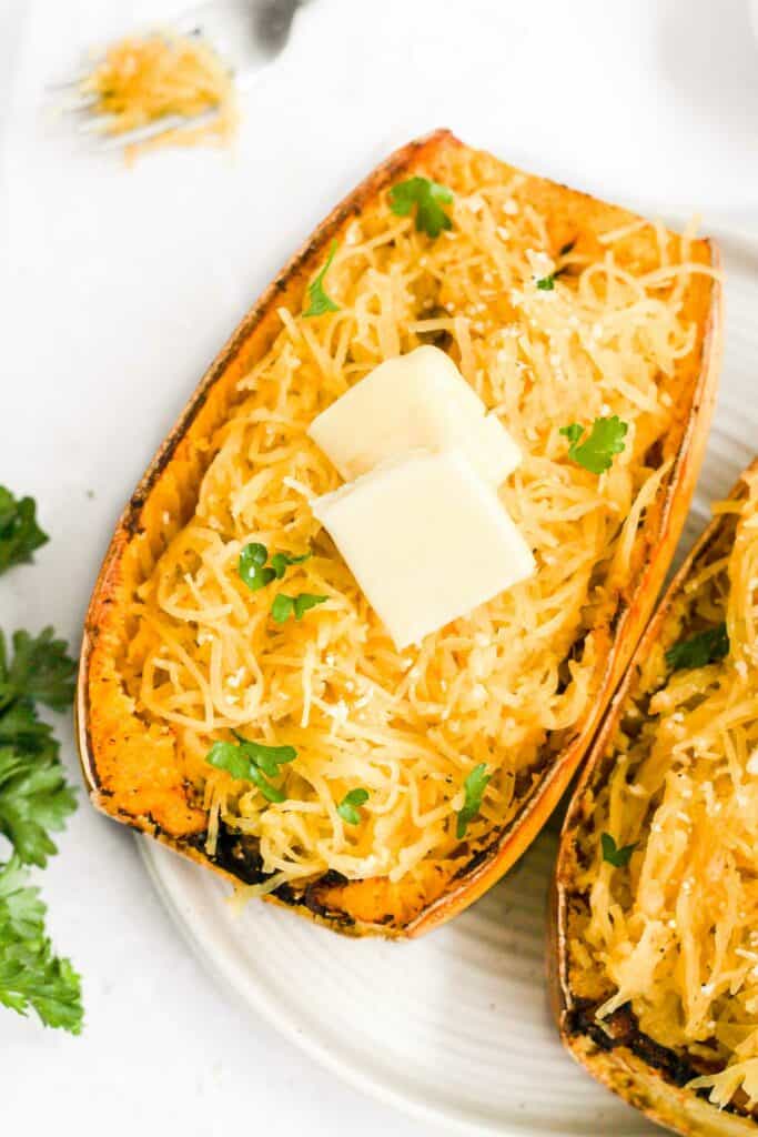 air fryer spaghetti squash topped with butter and herbs.