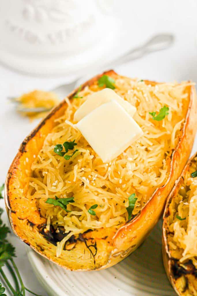 air fryer squash strands topped with herbs and butter.