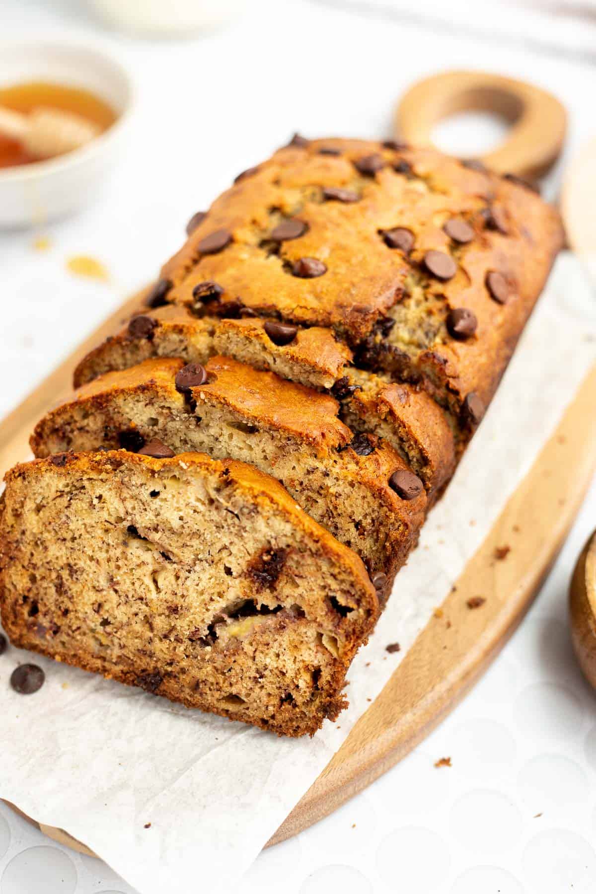 slices of dairy free banana bread with chocolate chips on parchment paper.