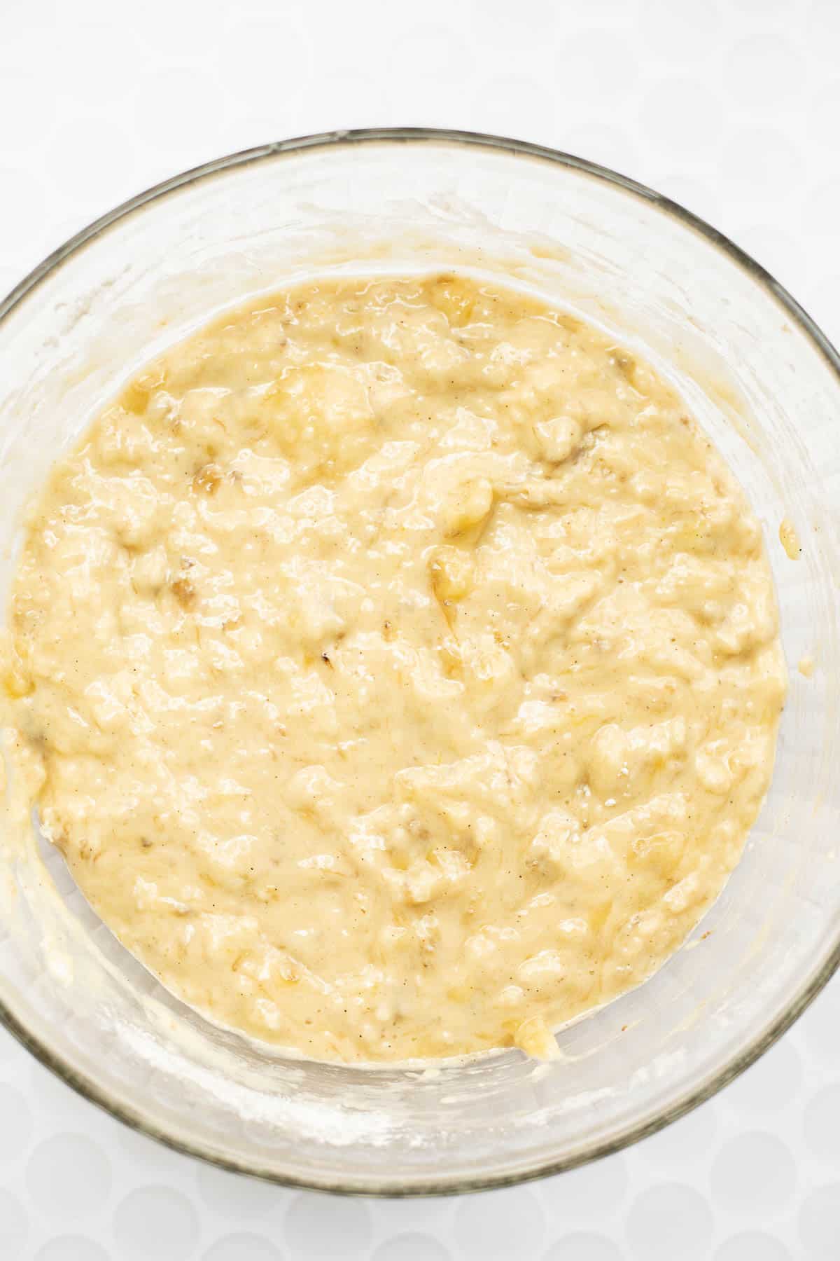 banana bread batter without butter in glass bowl.