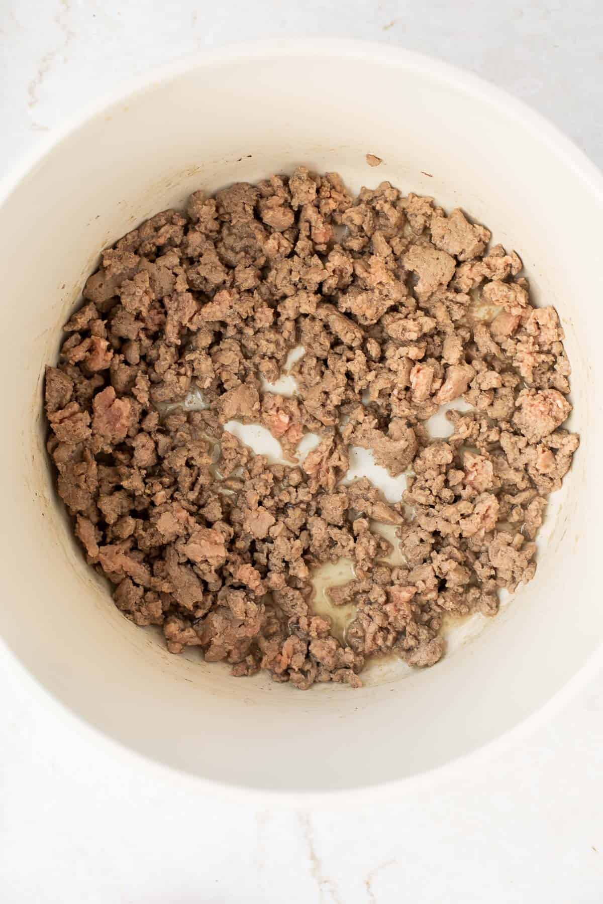 ground feed browned in white pot.