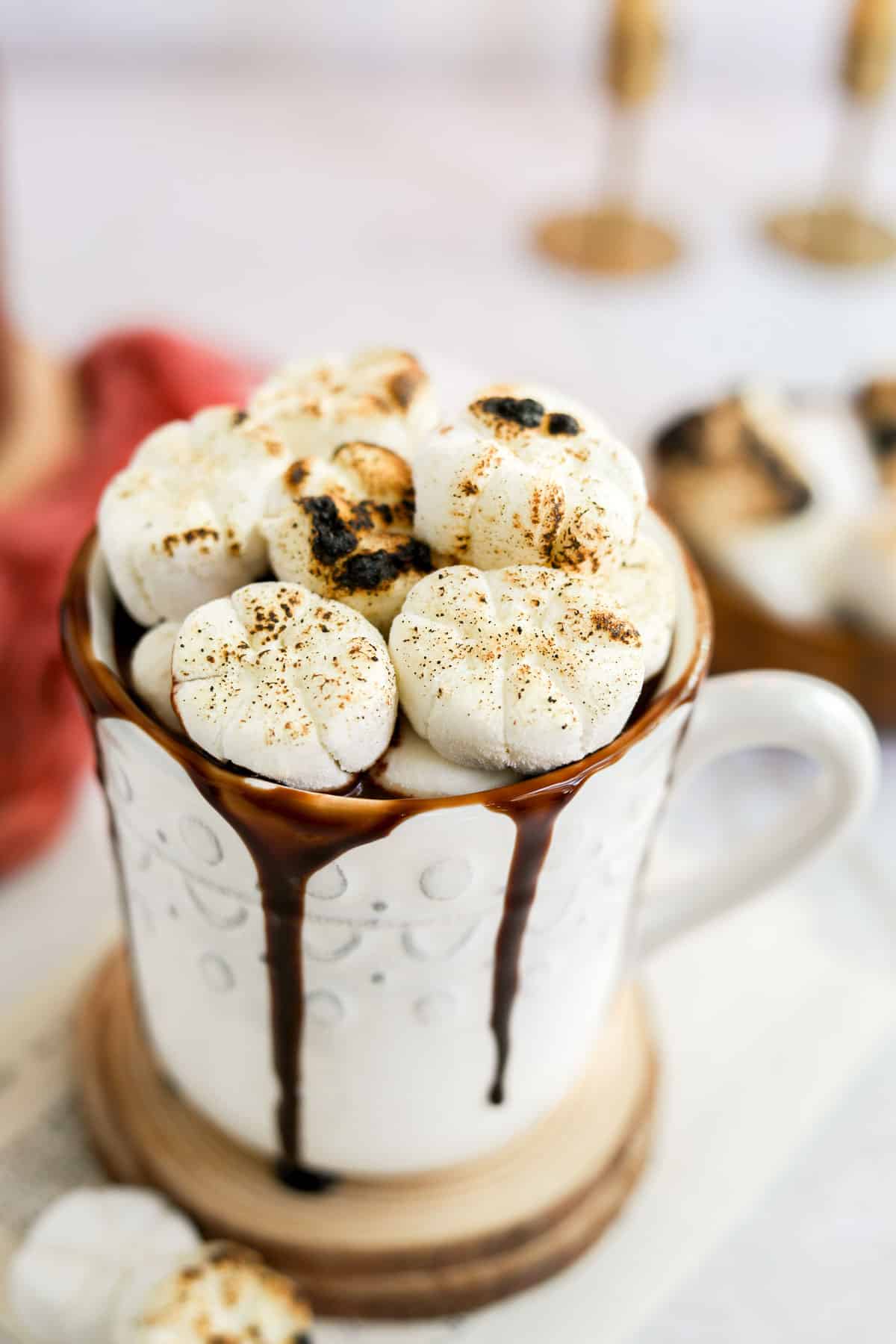 white mug of dairy free hot chocolate topped with marshmallows.