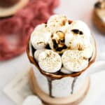 oat milk hot chocolate topped with toasted marshmallows in a white mug.