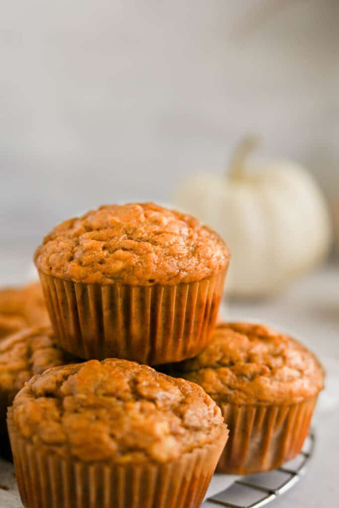 healthy pumpkin muffins stacked on top of each other.