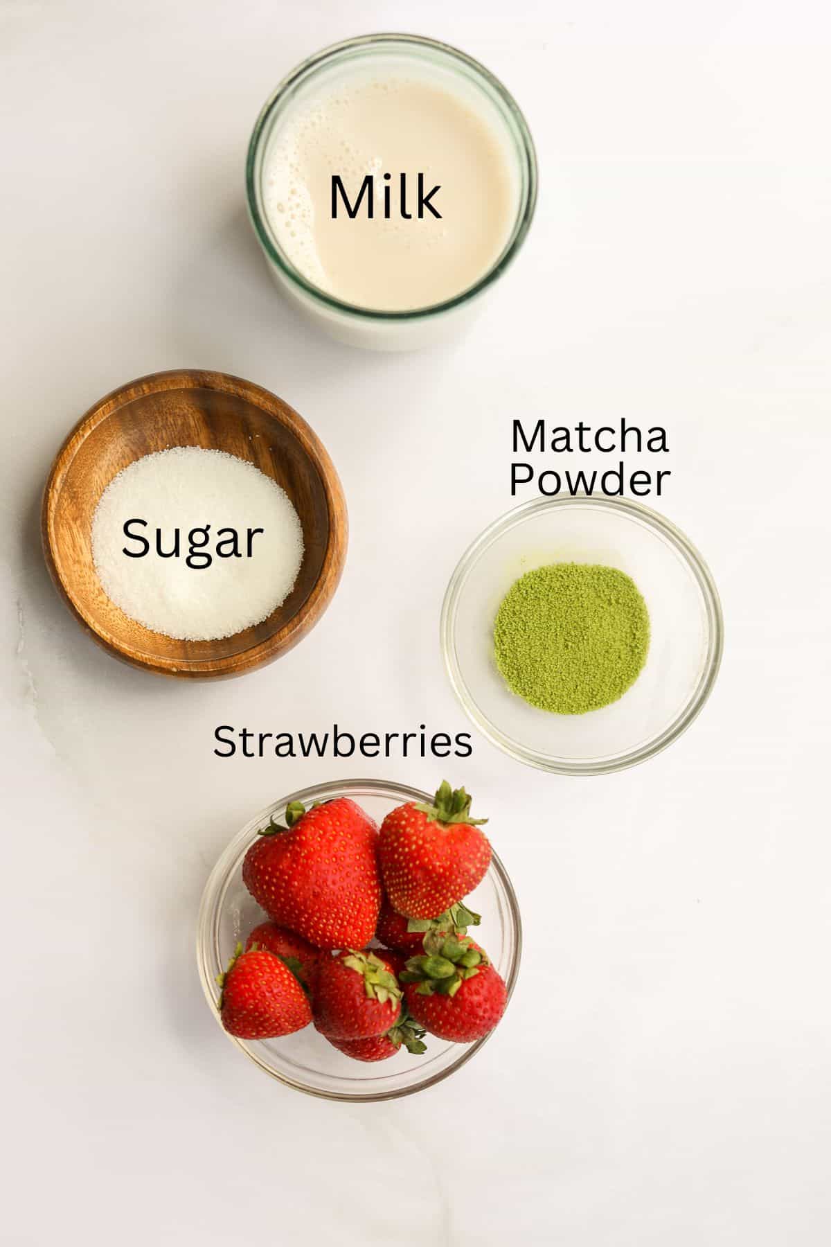 ingredients for a strawberry matcha latte labeled with black text.