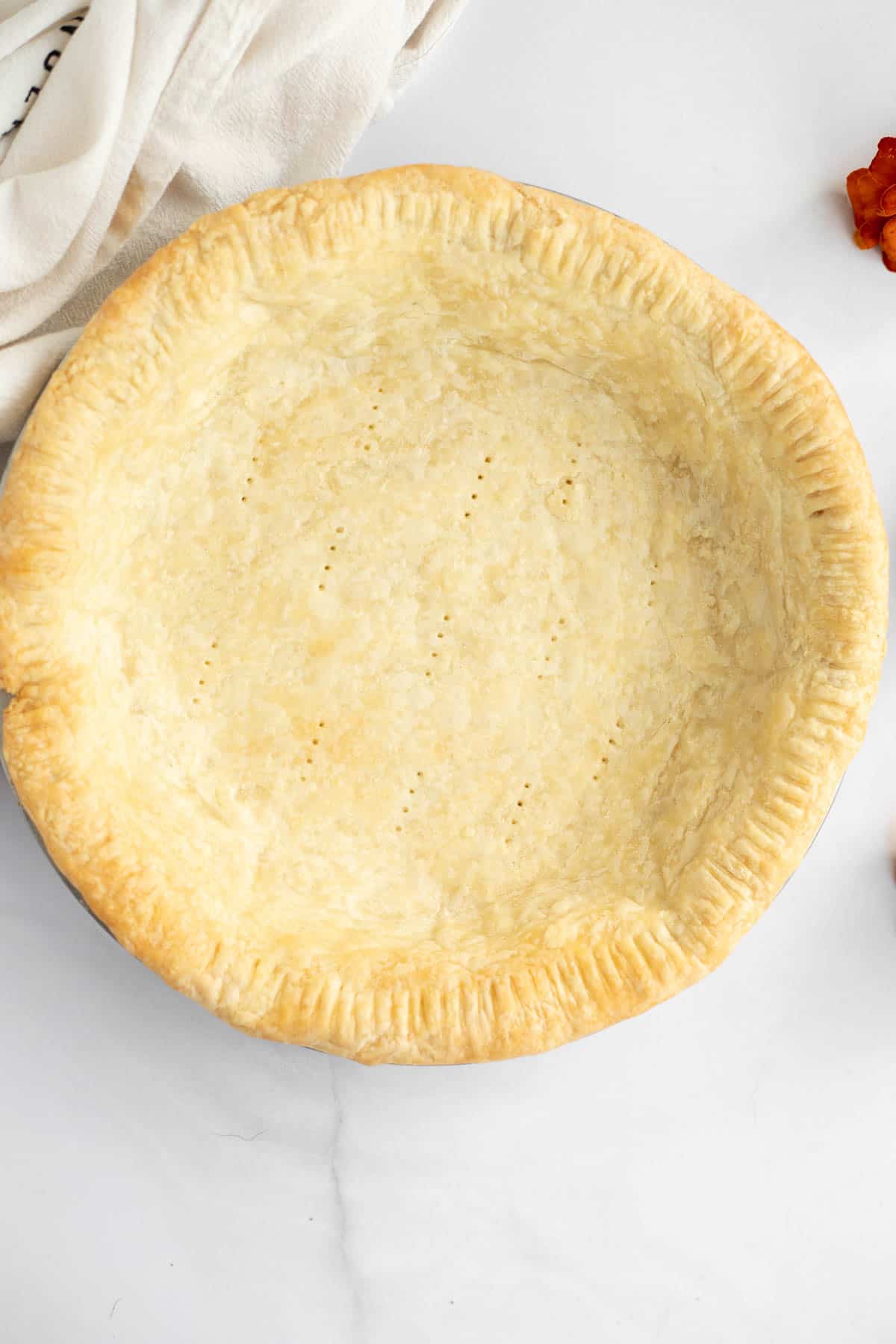 3 ingredient pie crust baked in a metal pie plate.