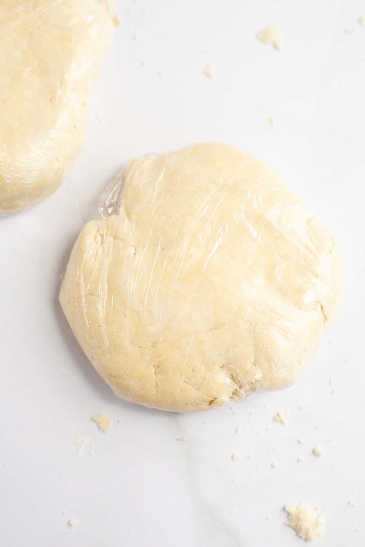 all butter pie crust dough wrapped in plastic wrap.