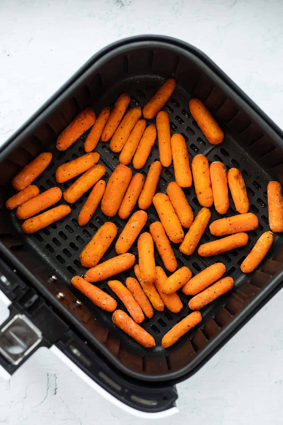 roasted carrots in black basket.