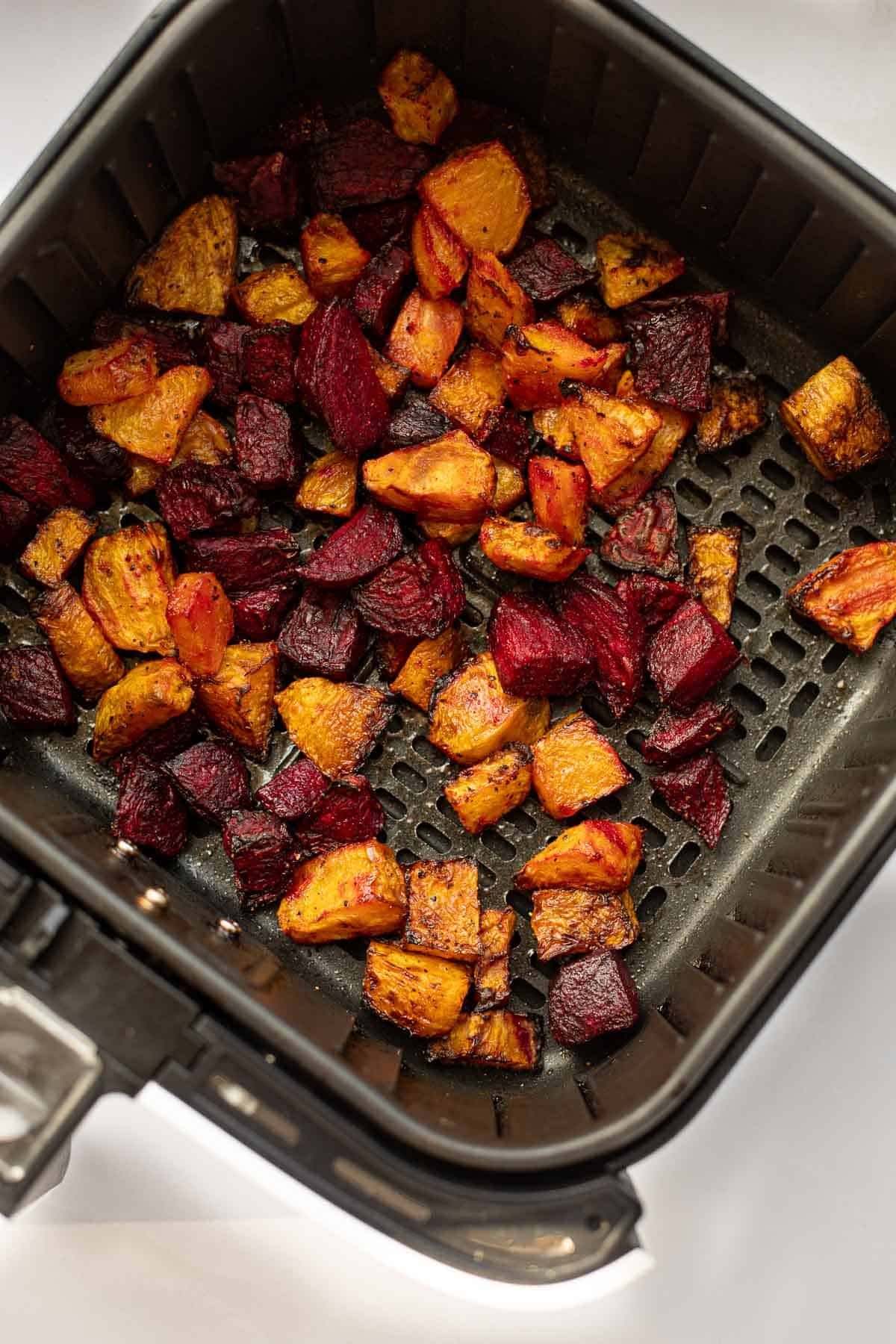 golden and red beets cooked in air fryer basket.